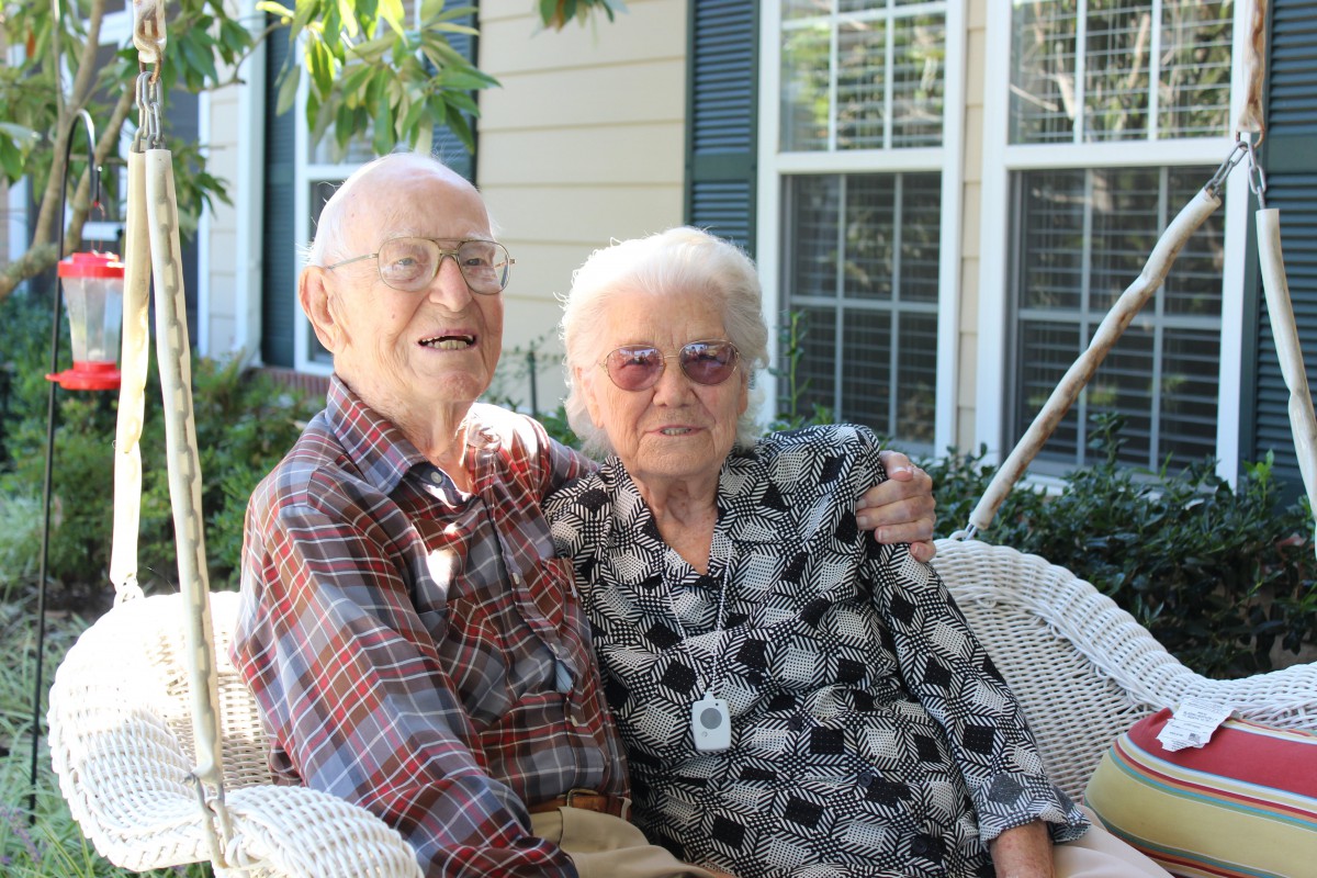 An elderly couple enjoying a moment together outside.