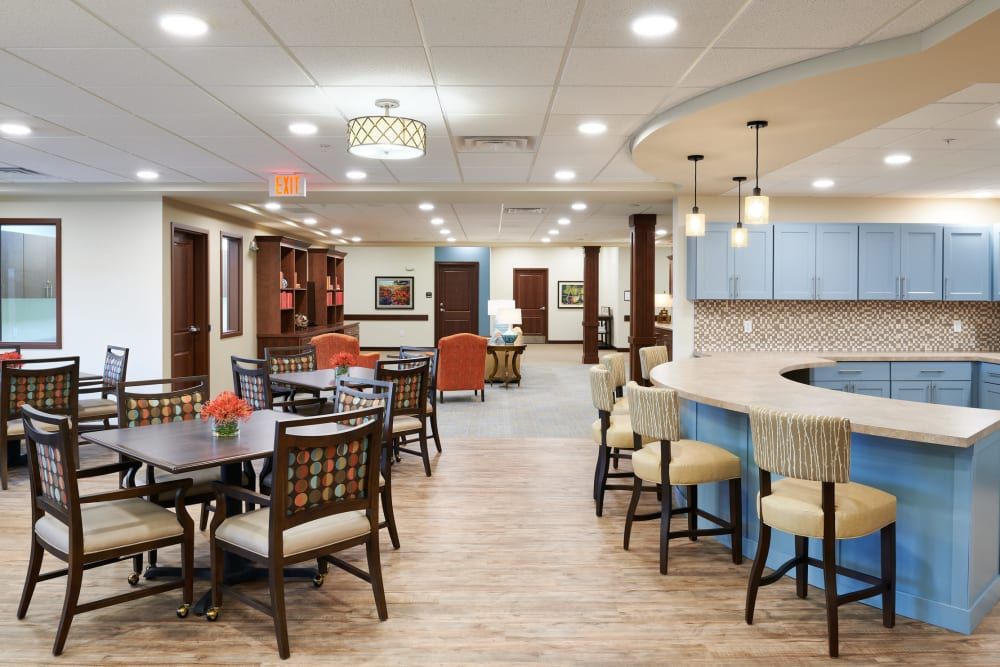 A modern communal dining area with a bar counter and comfortable seating.