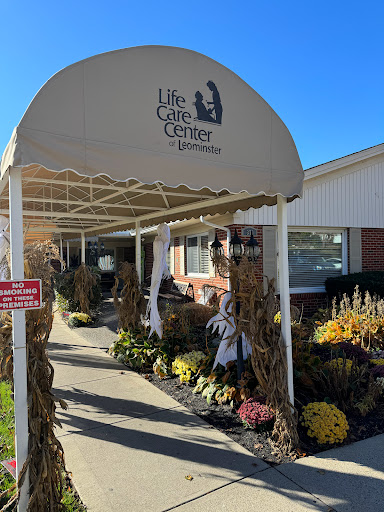 Entrance to the Life Care Center, adorned with autumn decorations and flowers.