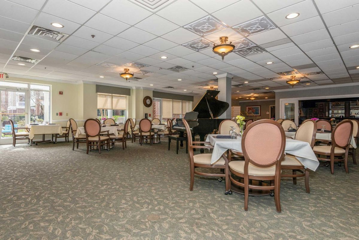 Luxurious dining room with elegant seating and a grand piano.