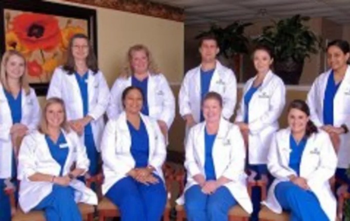 A group of medical professionals posing for a photo indoors.