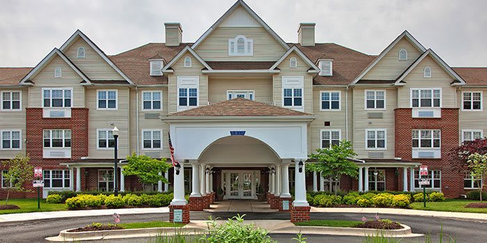 A picturesque residential building with a welcoming entrance and landscaped surroundings.