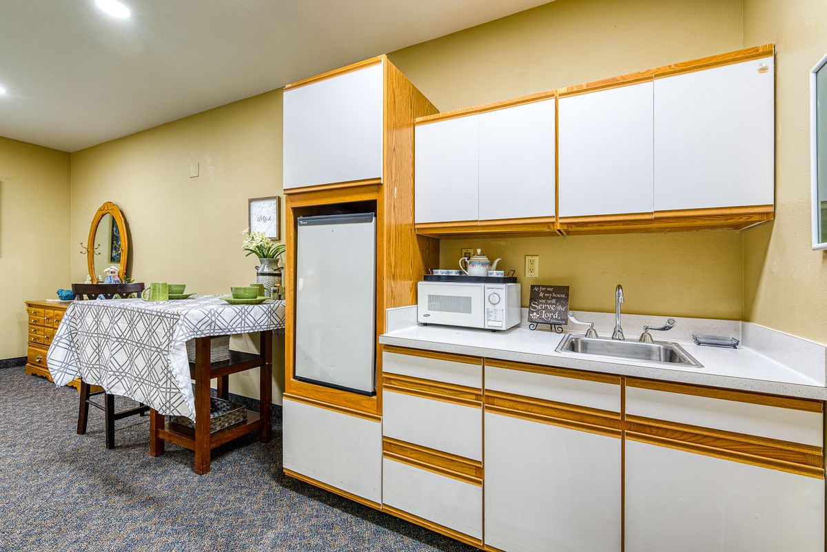 A retro-style kitchen with wooden cabinets and modern appliances.