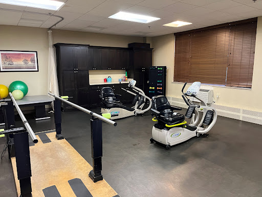 A well-equipped physical therapy room featuring various rehabilitation machines.