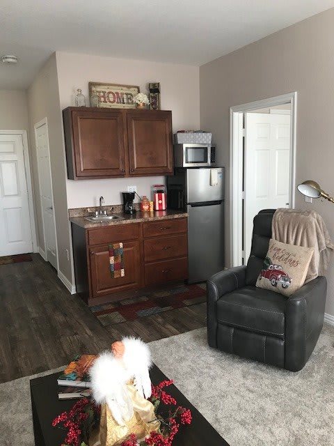 A cozy living space with a kitchenette and recliner.