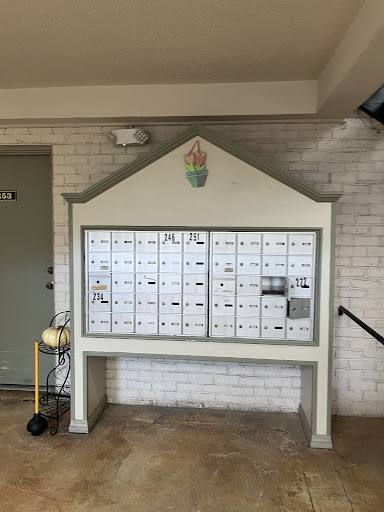 A community mailbox area featuring multiple mail slots and a decorative design.