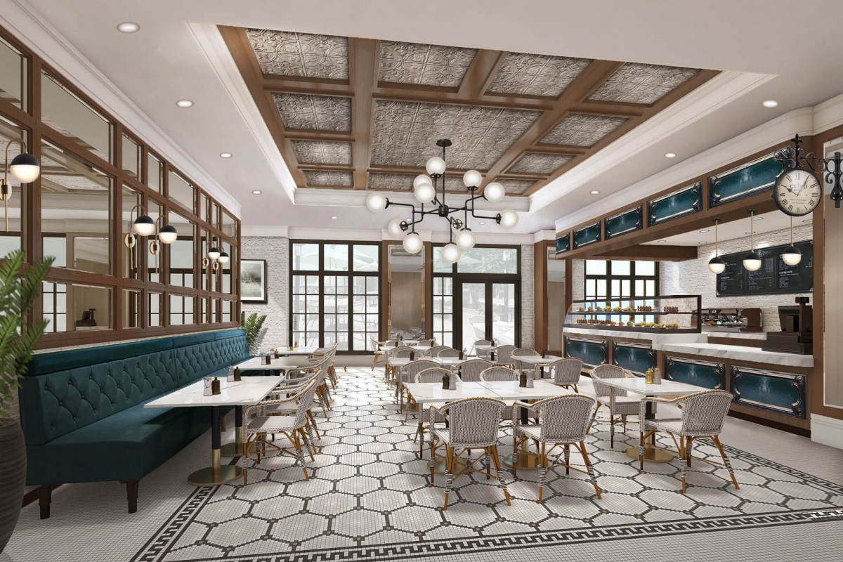 A modern restaurant interior featuring a stylish dining area with elegant chandeliers and chic decor.