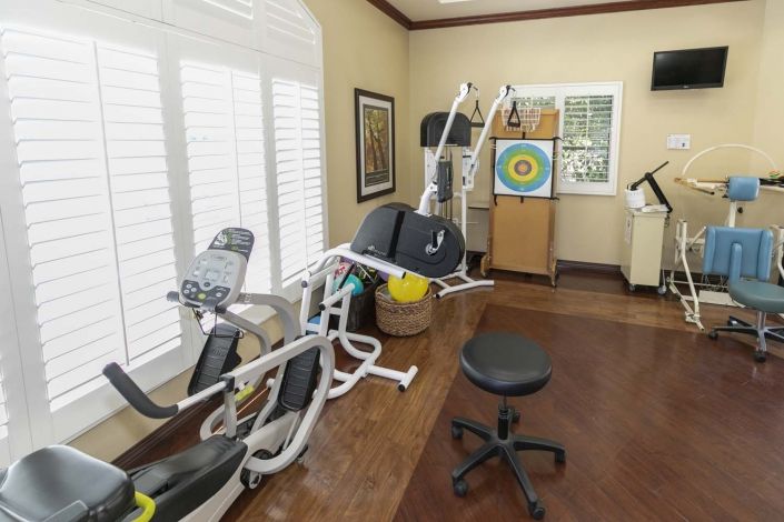 A therapy room equipped with exercise machines for rehabilitation and healthcare.