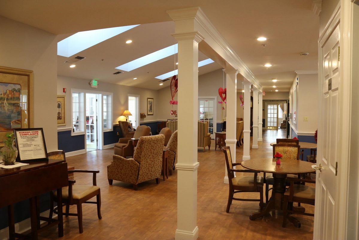 A spacious and well-lit interior with comfortable seating and elegant columns.