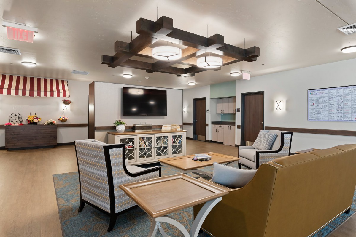 A modern living room with comfortable seating, a stylish lighting fixture, and neutral color tones.