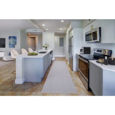 A modern kitchen with stainless steel appliances and an open floor plan.