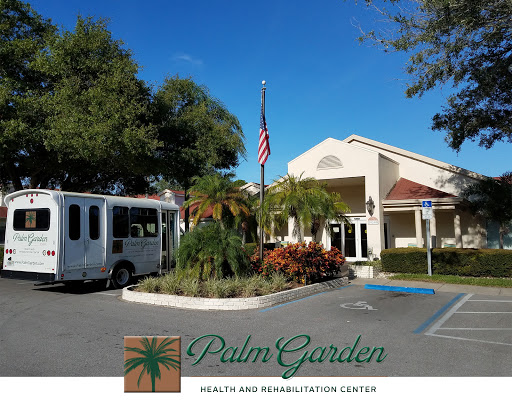 Exterior view of Palm Garden Rehabilitation Center with landscaped grounds and an American flag.