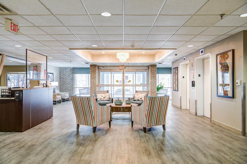 A welcoming lobby area featuring comfortable seating, elegant lighting, and access to elevators.
