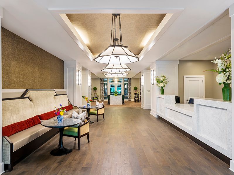 A modern hotel lobby with elegant seating and a stylish chandelier.
