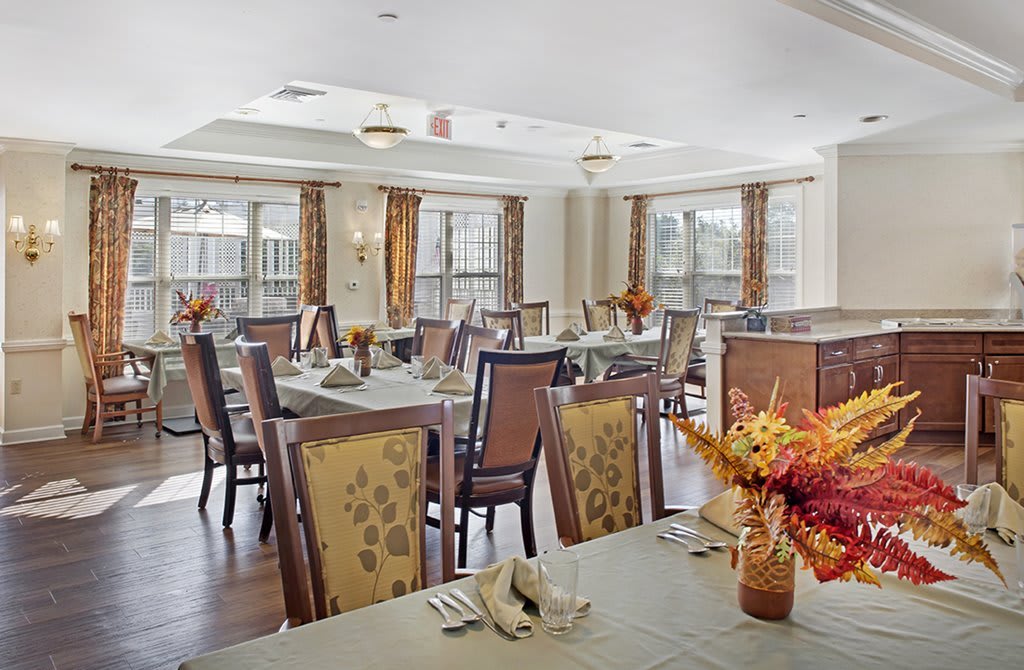 A well-decorated dining area with neatly arranged tables and chairs, featuring a cozy and inviting atmosphere.
