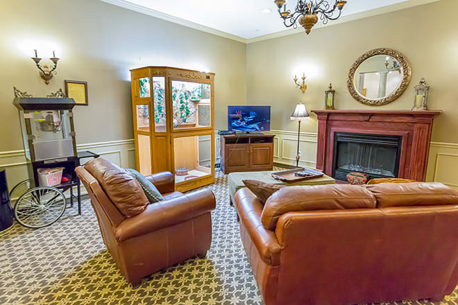 A cozy living room with sofas, a television, and a fireplace.