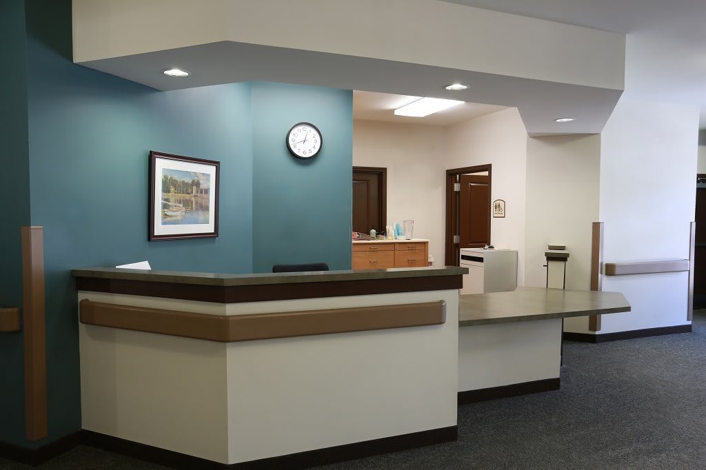 A modern reception area with a desk and waiting space.