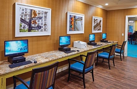 A row of computer workstations in a neatly arranged office space.