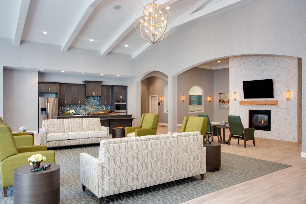 A modern and cozy living room with elegant furniture and a stylish chandelier.