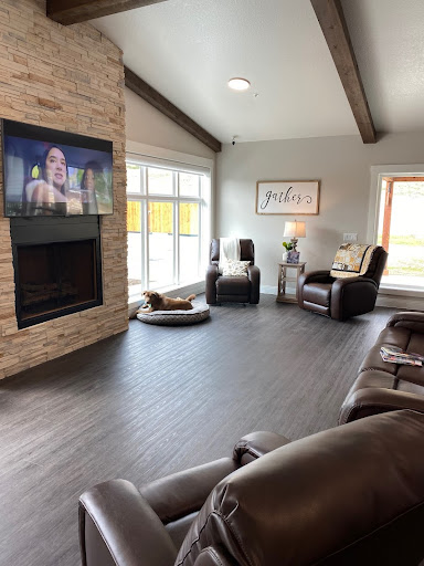 A spacious and inviting living room featuring a modern design with a fireplace and large windows.