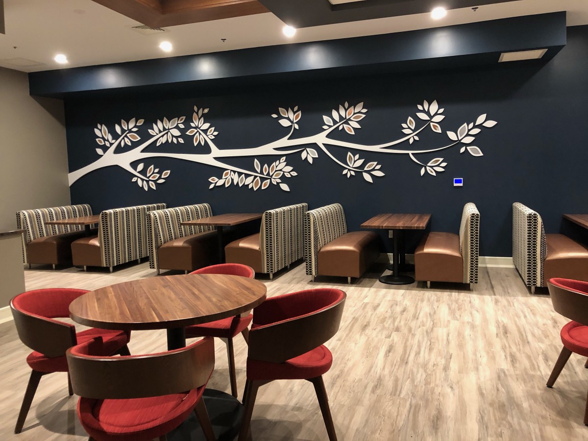 A modern restaurant interior featuring stylish seating and decorative wall art.