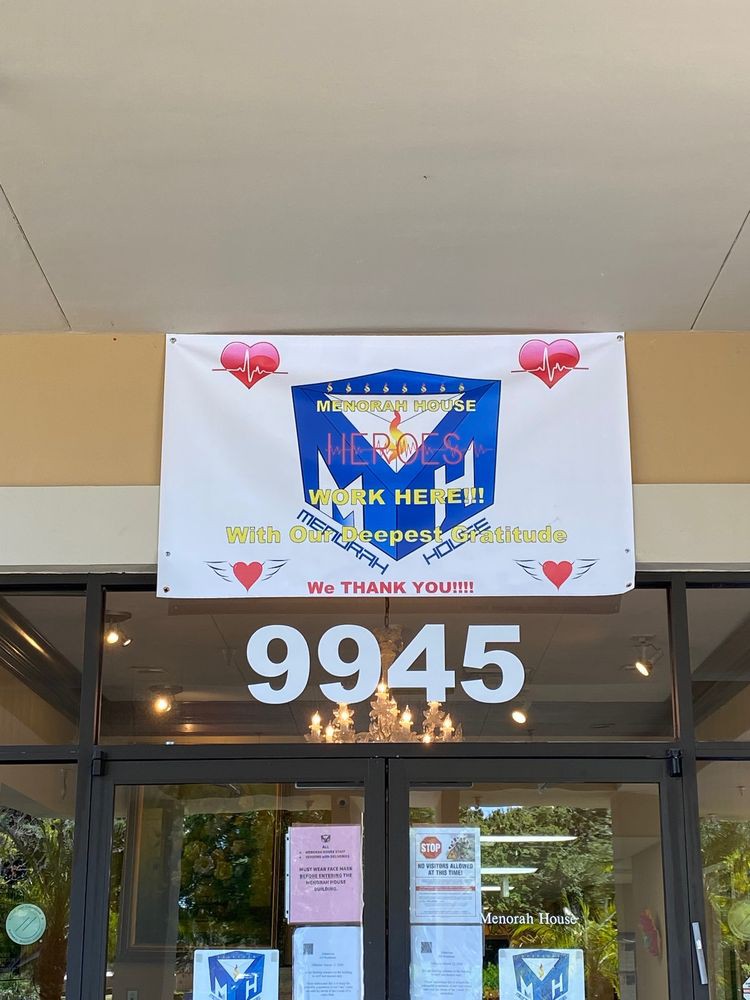 A storefront with a decorative banner displaying heart symbols and an address number.