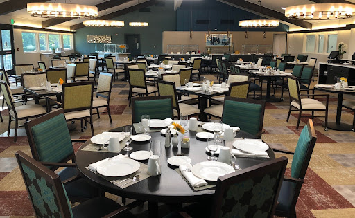 A spacious and elegantly arranged dining area with neatly set tables.