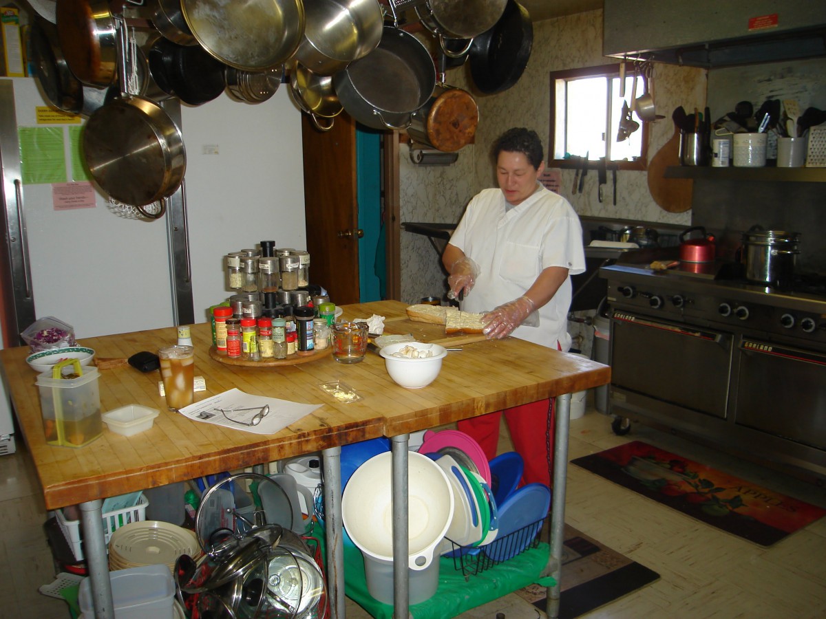 A person preparing food in a well-equipped kitchen.