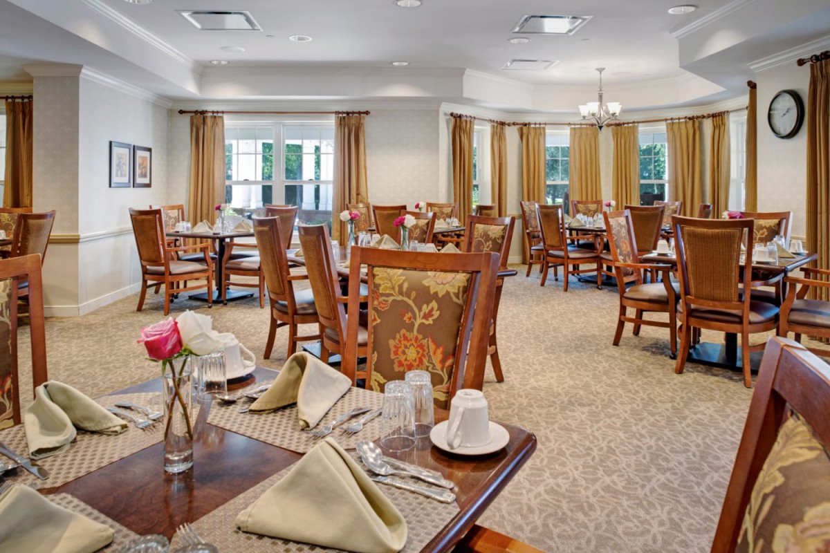 An elegantly decorated dining room with neatly arranged tables and chairs.