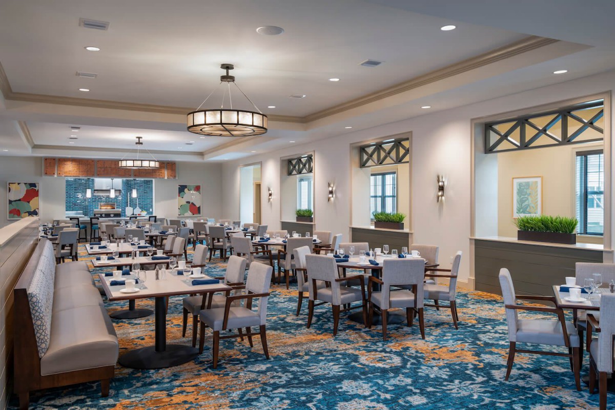 Spacious and elegantly designed restaurant dining area with neatly arranged tables and chairs.