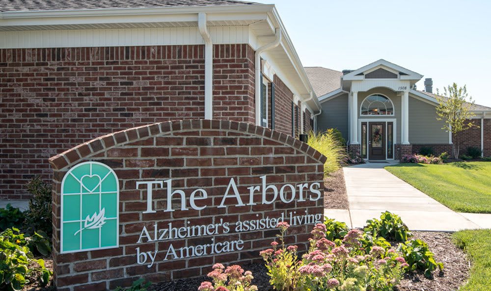 The Arbors Alzheimer's assisted living facility entrance with a brick sign.
