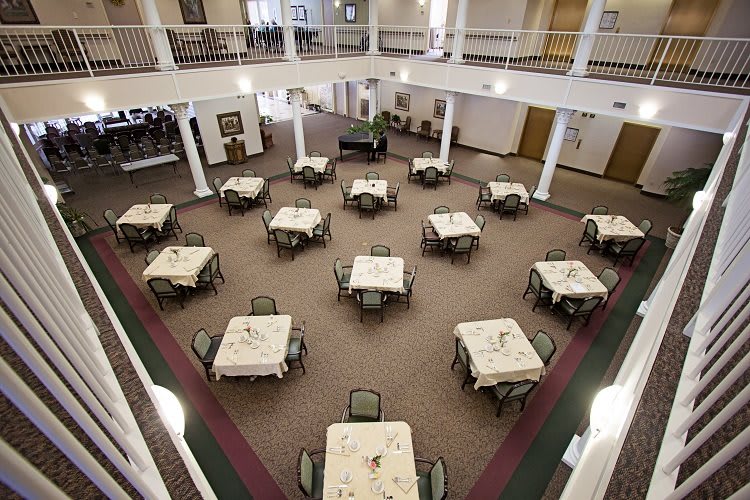 An indoor dining hall with neatly arranged tables and chairs.