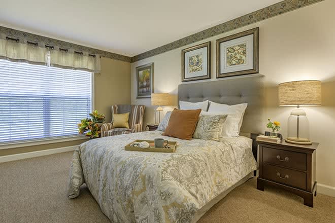 A cozy and well-decorated bedroom with a large bed and elegant artwork.