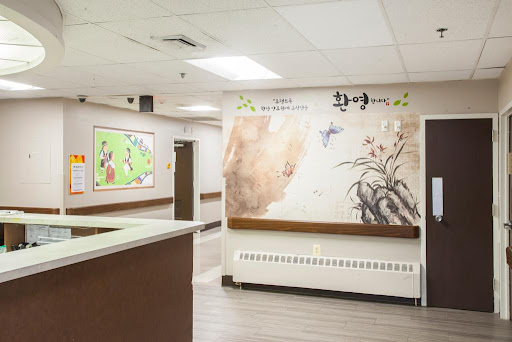 A welcoming hospital interior featuring a reception desk and decorative wall art.