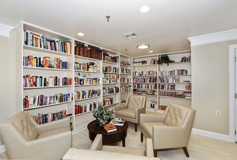 A cozy library with bookshelves and comfortable seating.