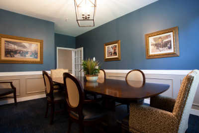 A stylish dining room with blue walls and elegant decor.