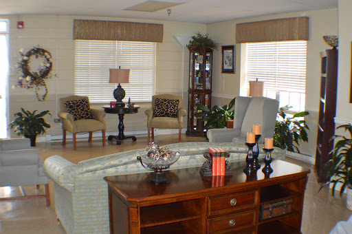 A cozy living room featuring comfortable seating, decorative elements, and abundant natural light.