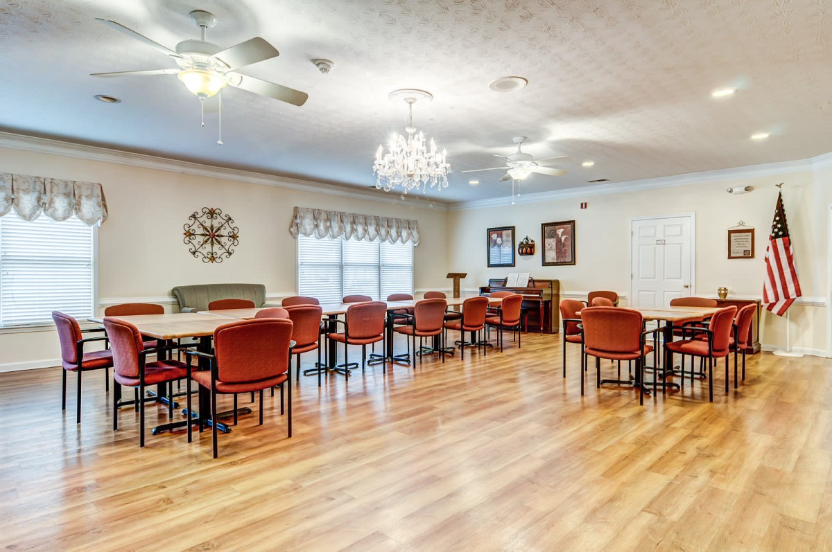 A spacious dining room with elegant decor and multiple tables and chairs.