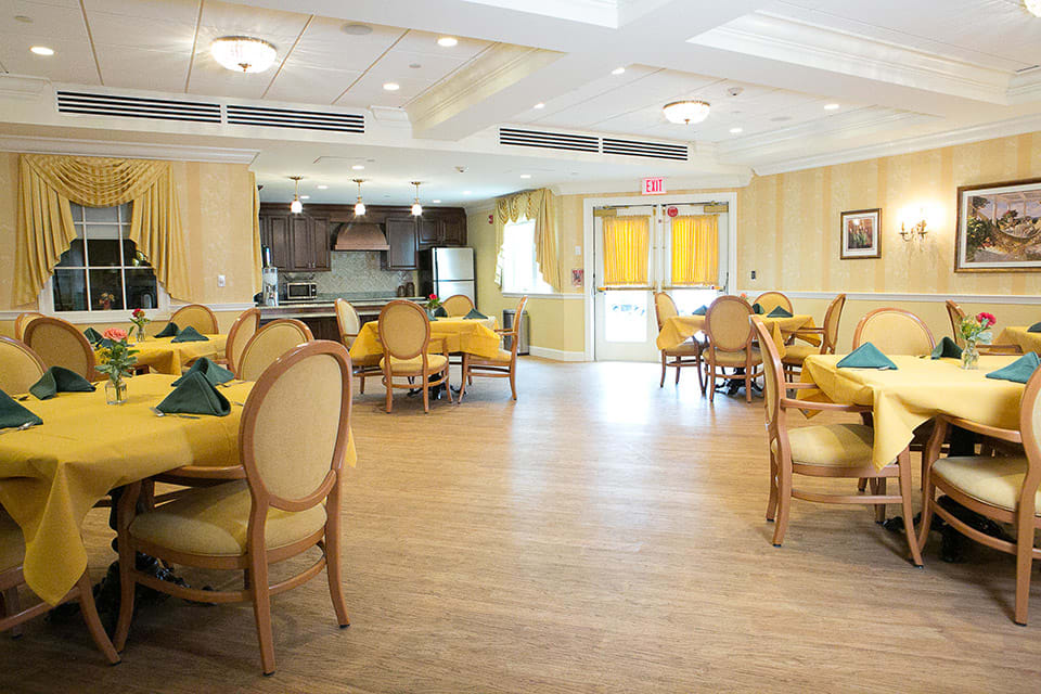 A bright and elegant dining room with neatly arranged tables and chairs.