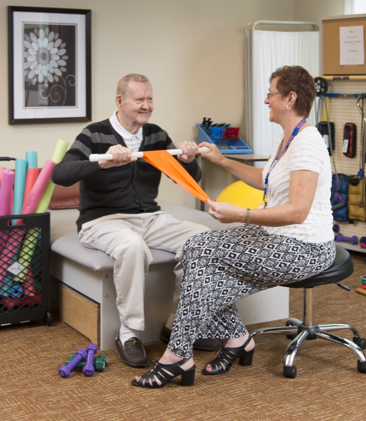 A physical therapist assists a patient with exercises during a rehabilitation session.