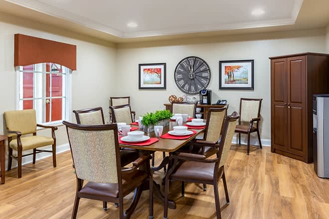A well-decorated dining room with a wooden table, elegant chairs, and tasteful wall art.