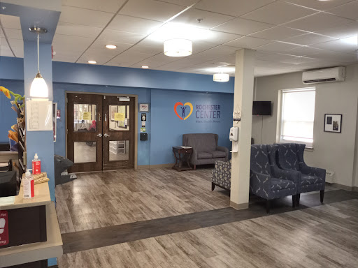 A spacious and welcoming waiting area in a healthcare facility, featuring comfortable seating and modern decor.