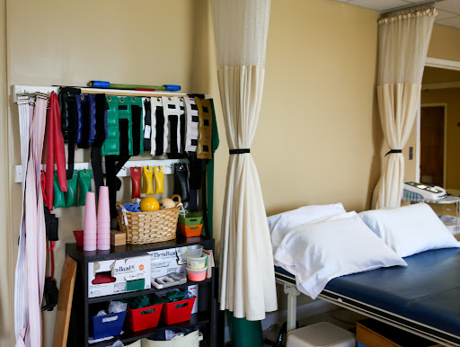 An organized therapy room featuring various exercise tools and equipment for rehabilitation.