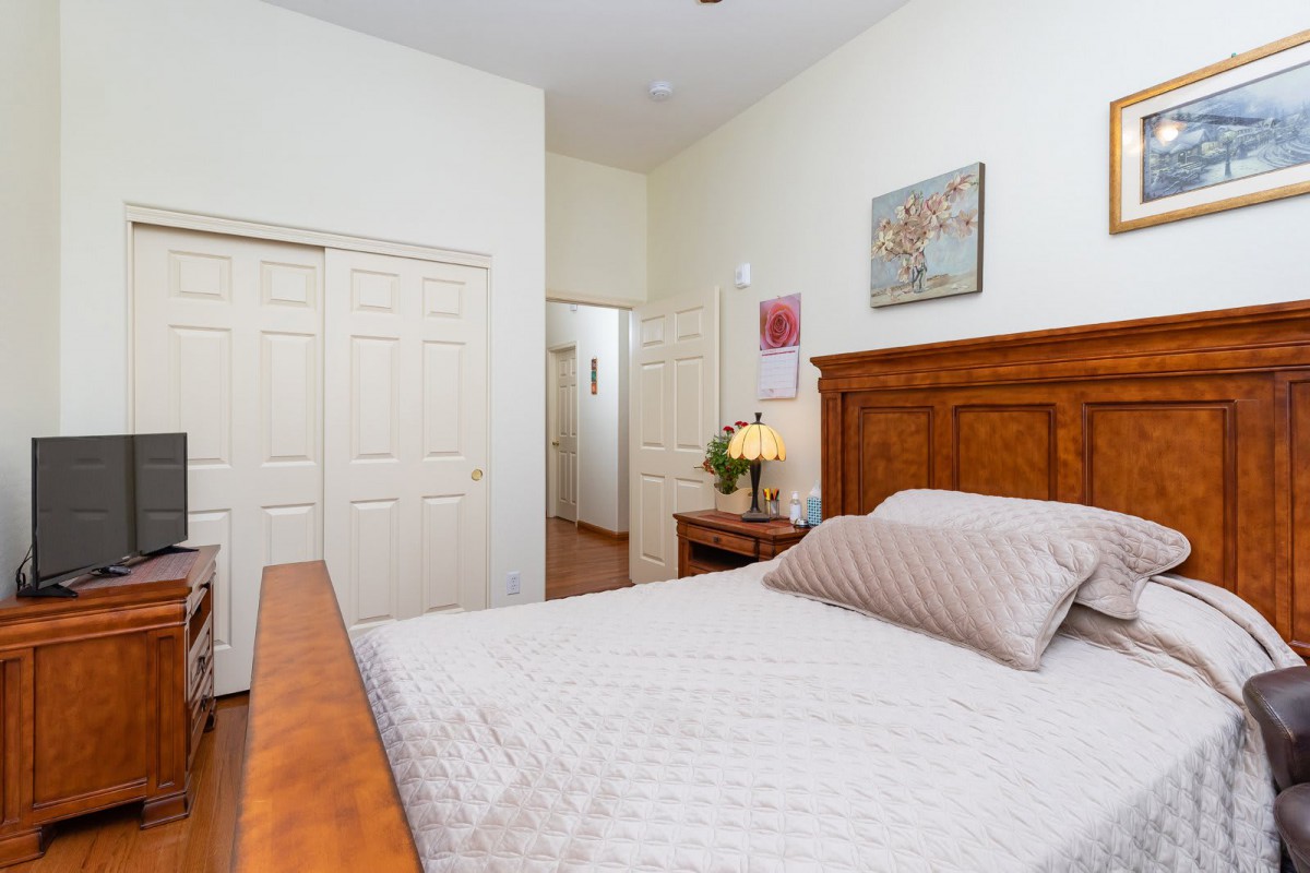 A cozy bedroom with a wooden bed and modern decor.