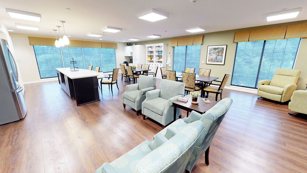 A spacious and modern living and dining area with comfortable seating and large windows.