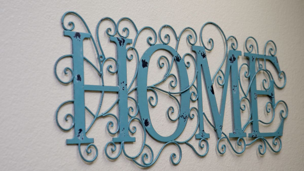Ornate blue metal wall art spelling 'HOME'.