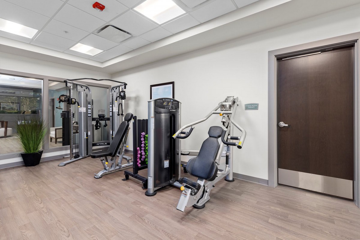 A well-equipped indoor gym featuring various exercise machines.