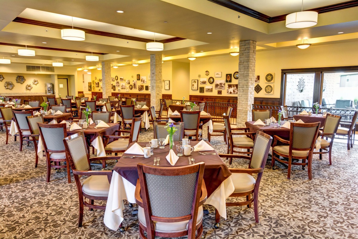 An elegant restaurant dining room with neatly arranged tables and chairs.