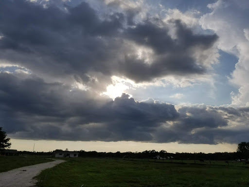 A serene moment captured as sunlight breaks through the clouds over a vast landscape.