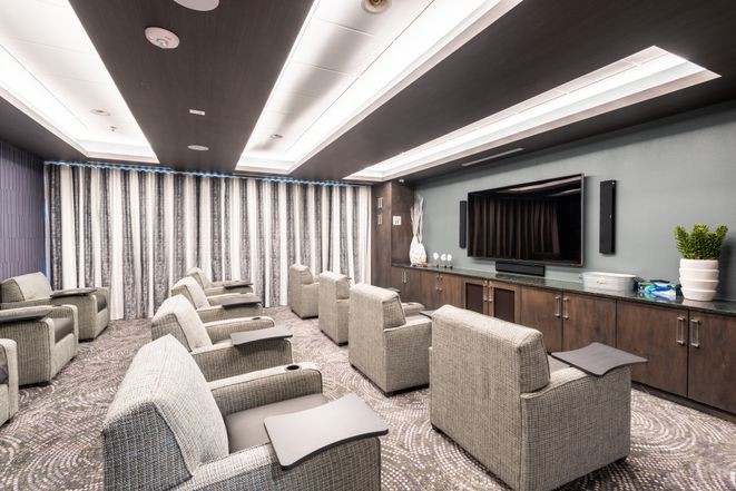 A modern home theater with plush seating and a large screen for an immersive entertainment experience.